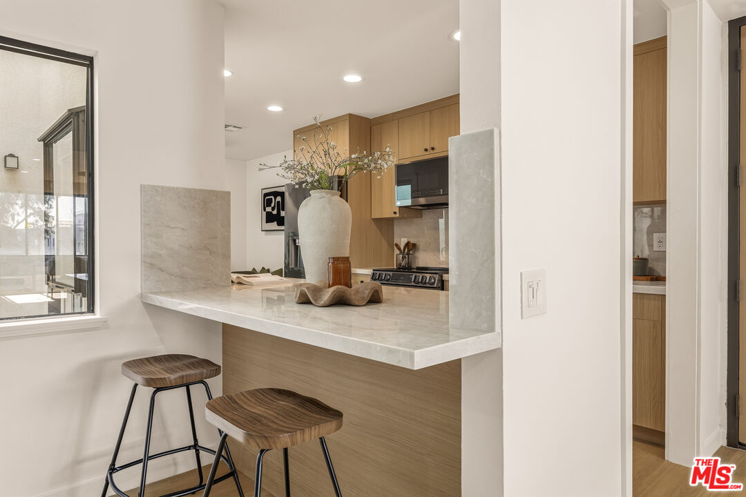 311 Bora Bora Way, Unit 3207 Marina del Rey, CA 90292 - Photo 14 of 54 a kitchen with kitchen island cabinets and appliances