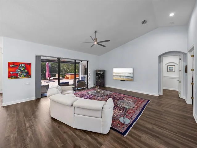 a kitchen with stainless steel appliances granite countertop a table chairs stove and wooden floor