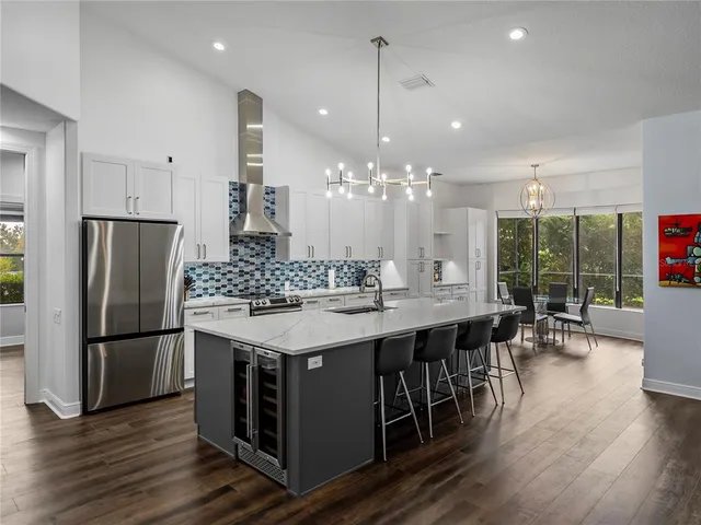 a kitchen with stainless steel appliances a sink stove and refrigerator