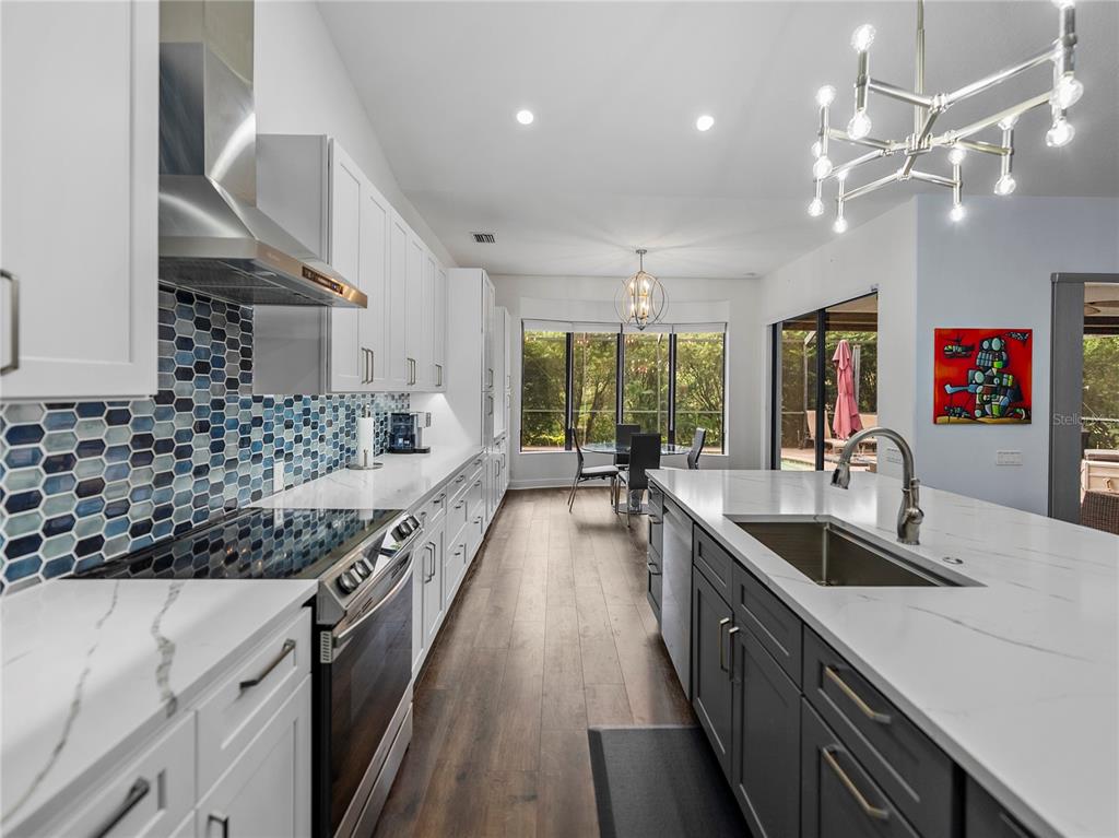 34120 Americana Avenue Dade City, FL 33525 - Photo 19 of 71 a kitchen with stainless steel appliances a sink stove and refrigerator