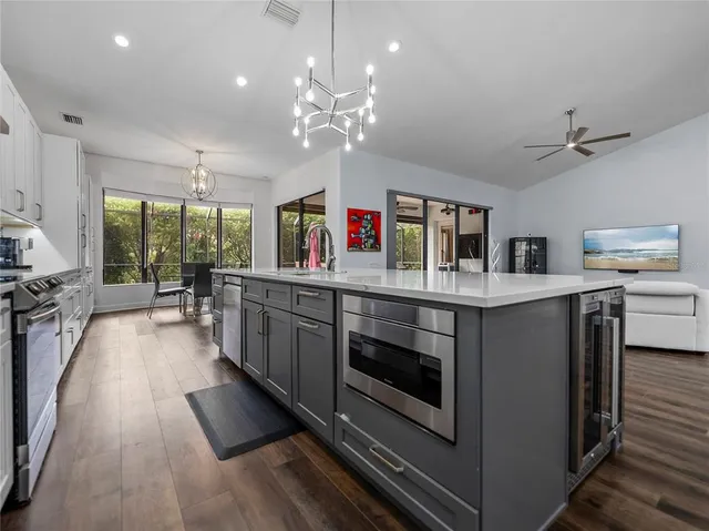 a view of a dining room with furniture large windows and wooden floor