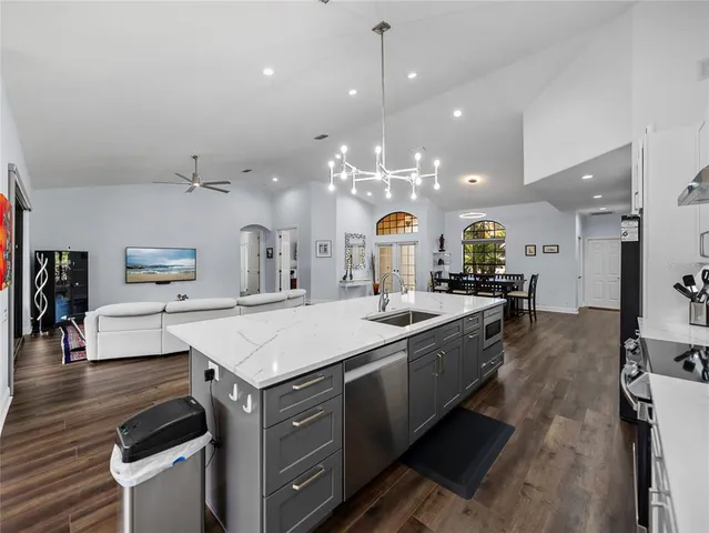 a kitchen with a dining table chairs refrigerator and cabinets