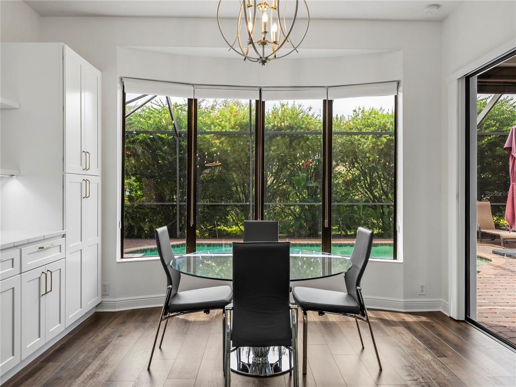 34120 Americana Avenue Dade City, FL 33525 - Photo 23 of 71 a view of a dining room with furniture window and wooden floor