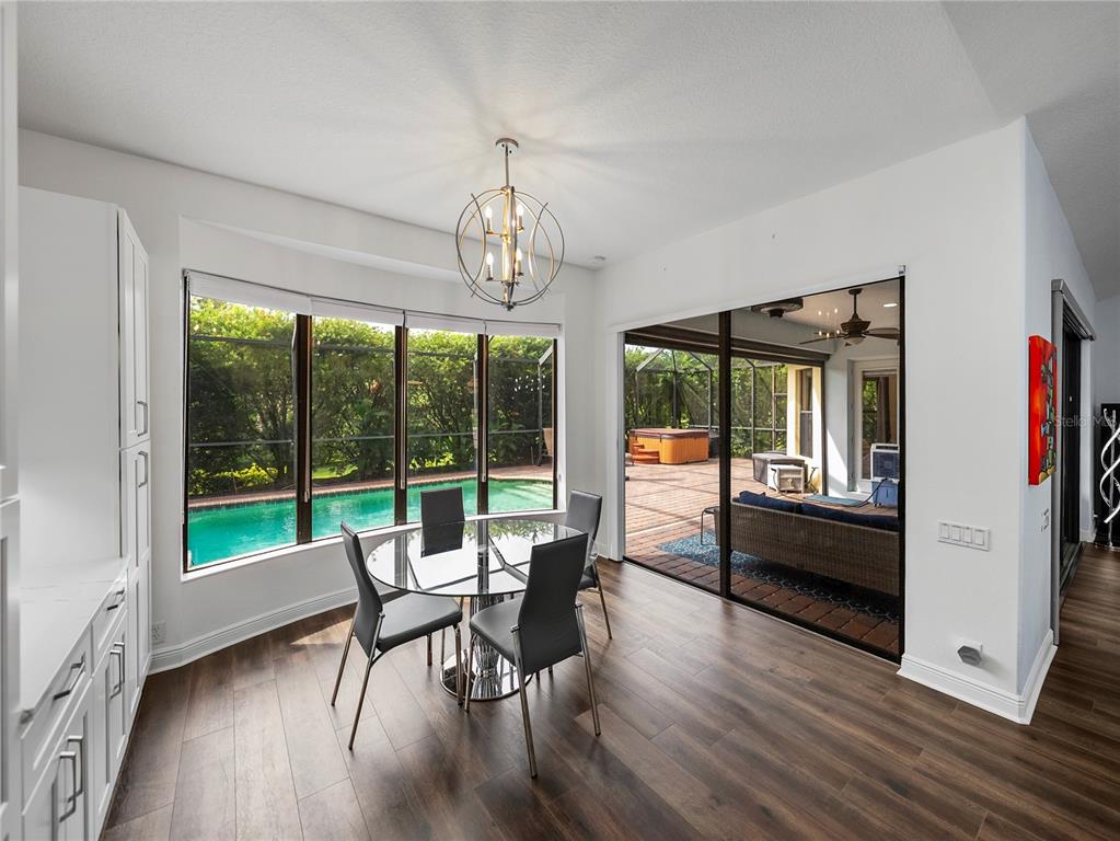 34120 Americana Avenue Dade City, FL 33525 - Photo 24 of 71 a view of a dining room with furniture large windows and wooden floor