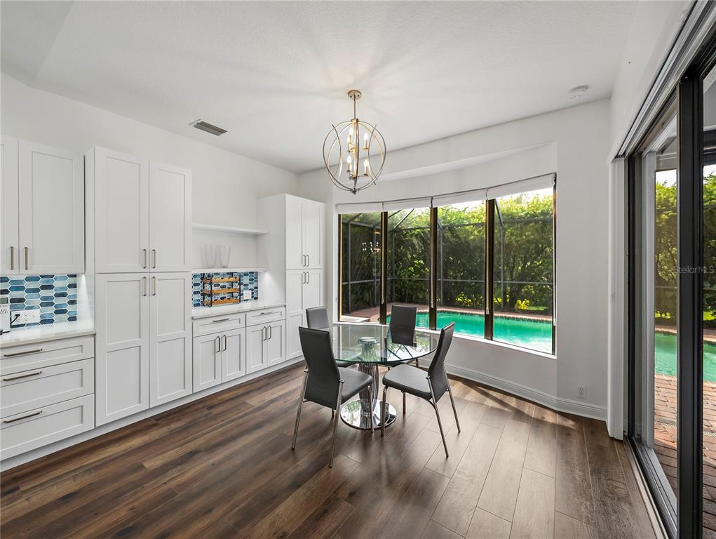 34120 Americana Avenue Dade City, FL 33525 - Photo 25 of 71 a view of a dining room with furniture a chandelier and wooden floor