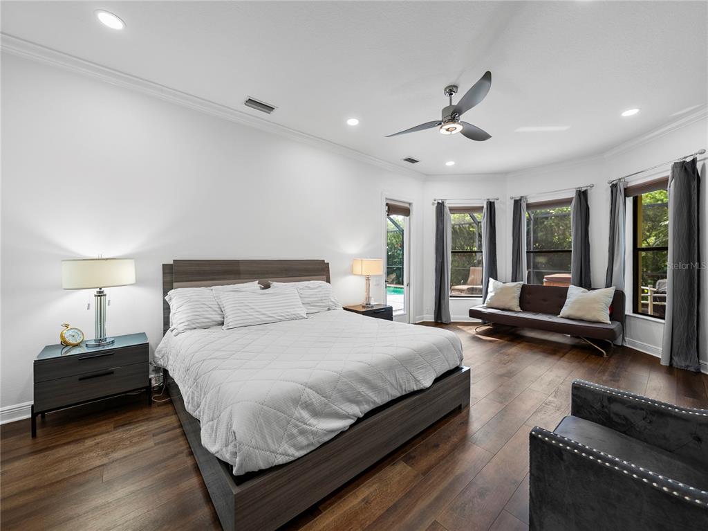 34120 Americana Avenue Dade City, FL 33525 - Photo 30 of 71 a bedroom with a bed couch and a large window