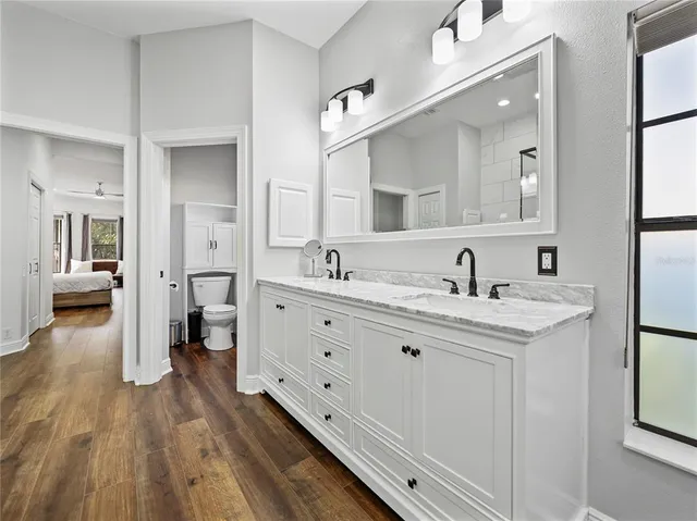 a bedroom with a large bed and a window