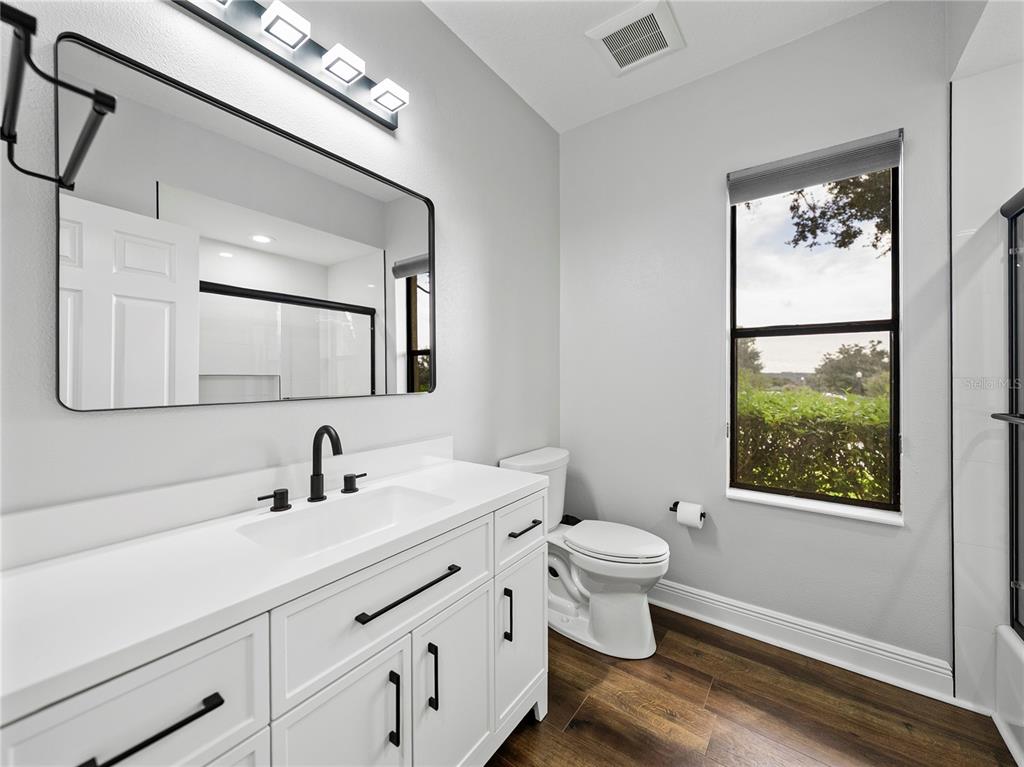 34120 Americana Avenue Dade City, FL 33525 - Photo 42 of 71 a bathroom with a toilet sink and mirror