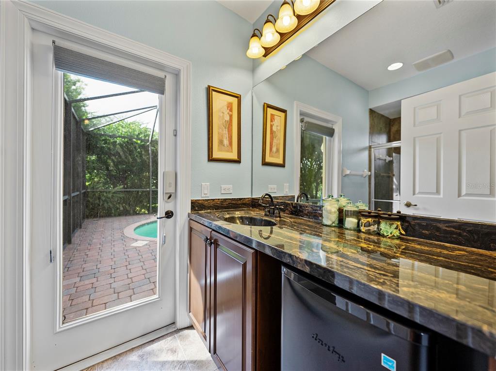 34120 Americana Avenue Dade City, FL 33525 - Photo 46 of 71 a bathroom with a granite countertop sink and a mirror