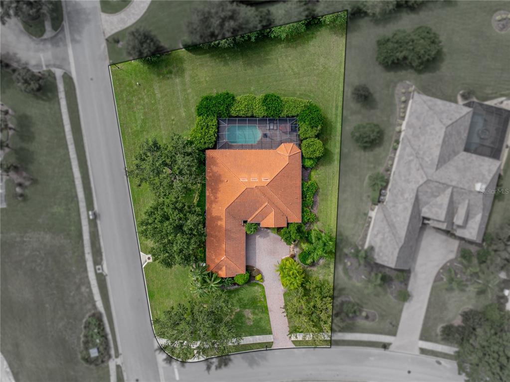 34120 Americana Avenue Dade City, FL 33525 - Photo 5 of 71 an aerial view of a house with garden space and a lake view