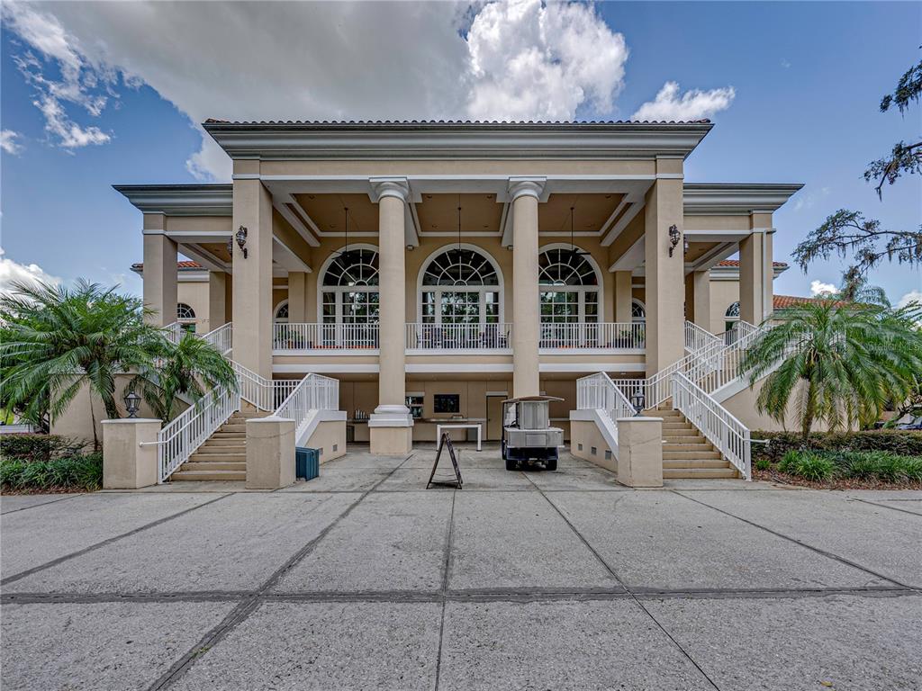 34120 Americana Avenue Dade City, FL 33525 - Photo 57 of 71 a view of a building with a bench and potted plants