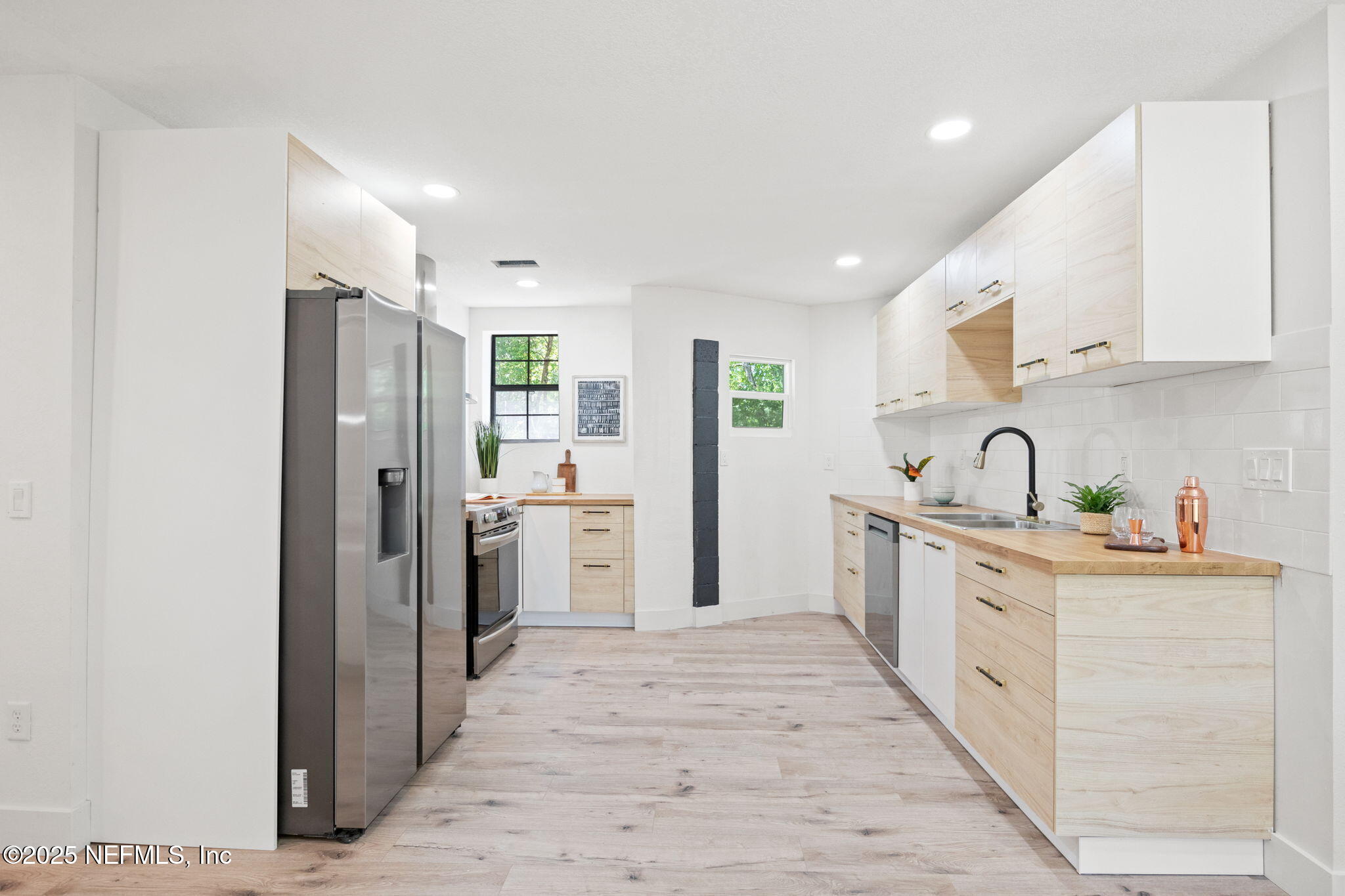 10024 Sandler Road Jacksonville, FL 32222 - Photo 13 of 40 a large white kitchen with stainless steel appliances