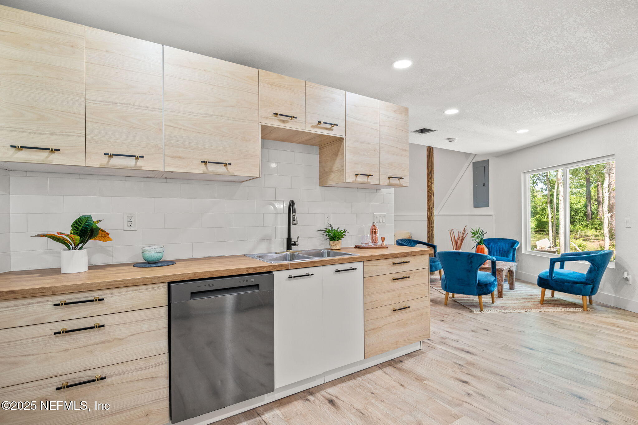 10024 Sandler Road Jacksonville, FL 32222 - Photo 14 of 40 a kitchen with a white cabinets sink and stove