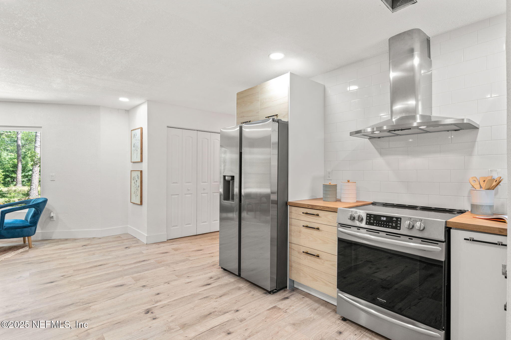 10024 Sandler Road Jacksonville, FL 32222 - Photo 15 of 40 a kitchen with stainless steel appliances granite countertop a refrigerator a stove and a sink with wooden floor