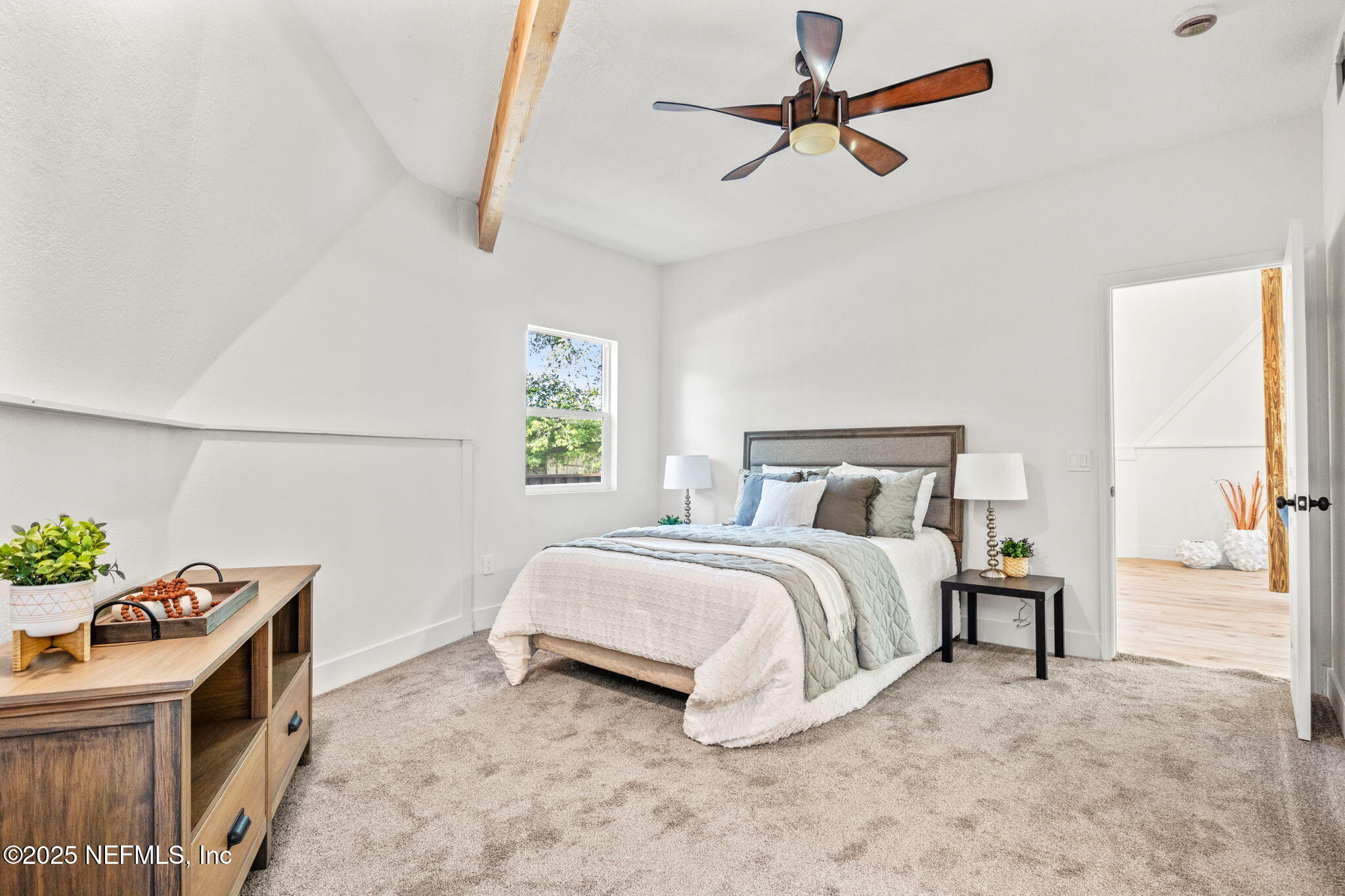 10024 Sandler Road Jacksonville, FL 32222 - Photo 17 of 40 a spacious bedroom with a bed and a chandelier