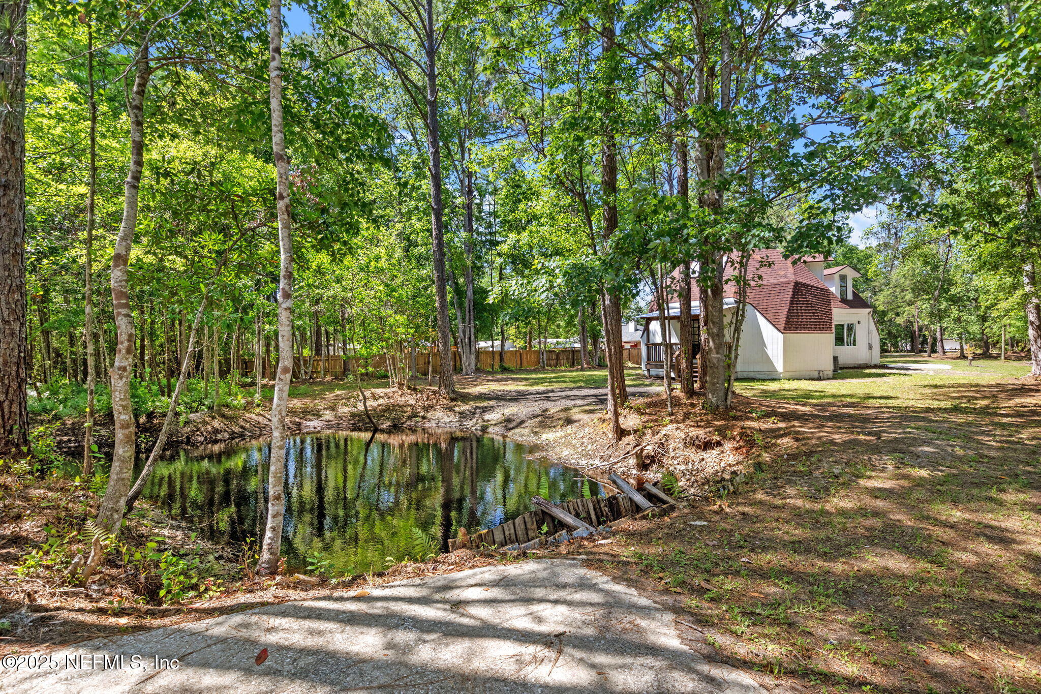 10024 Sandler Road Jacksonville, FL 32222 - Photo 33 of 40 a view of a yard with plants and trees