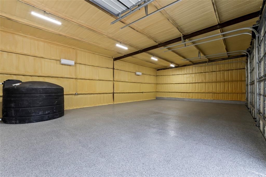 4054 Smothers Road Caney City, TX 75148 - Photo 33 of 40 Interior of the 4 Bay Shop. Insulated w/ Spray Form and Climate Controlled. Perfect for the car collector or turn it into a huge game room! Pictures is the 1550 gal fresh water storage tank.