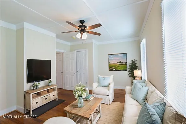 a living room with furniture and a flat screen tv