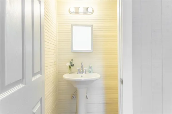 a bathroom with a sink a mirror and a shower