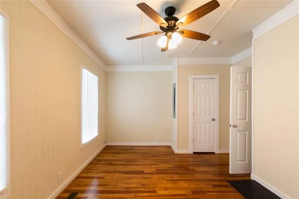a view of an empty room and wooden floor