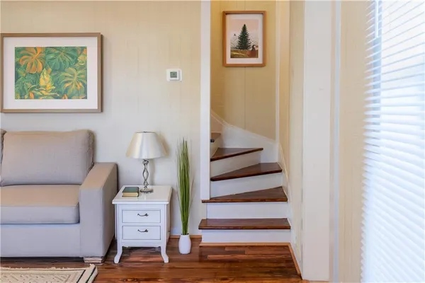 a view of room with furniture and wooden floor