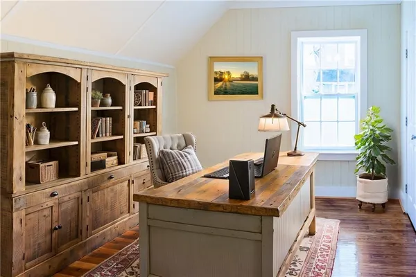 a living room with furniture and painting on the wall