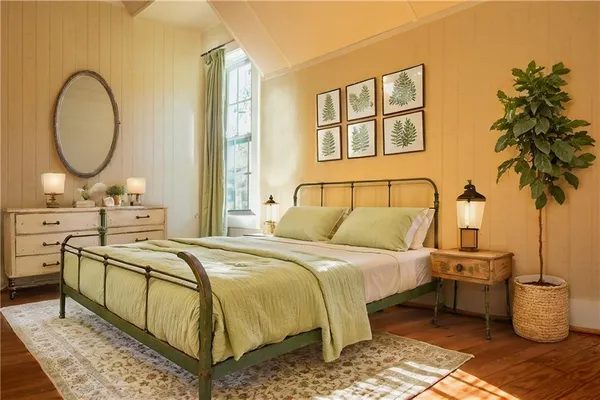 a bed room with a bed and a potted plant