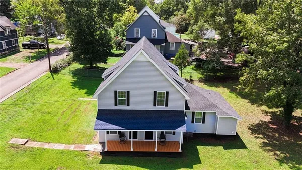 a view of house with backyard and swimming pool