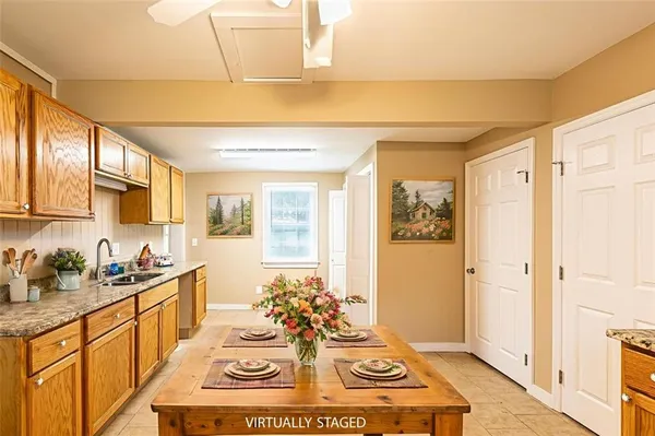 a spacious bathroom with a double vanity sink a mirror and a shower