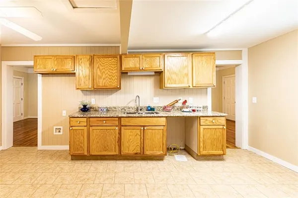 a large bathroom with a granite countertop sink and a large mirror