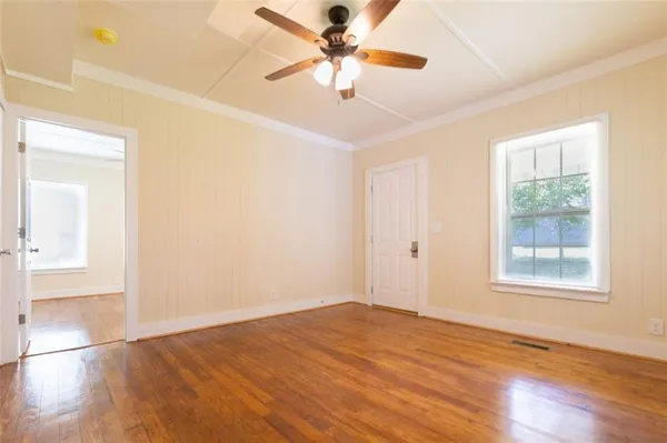 wooden floor in an empty room with a window