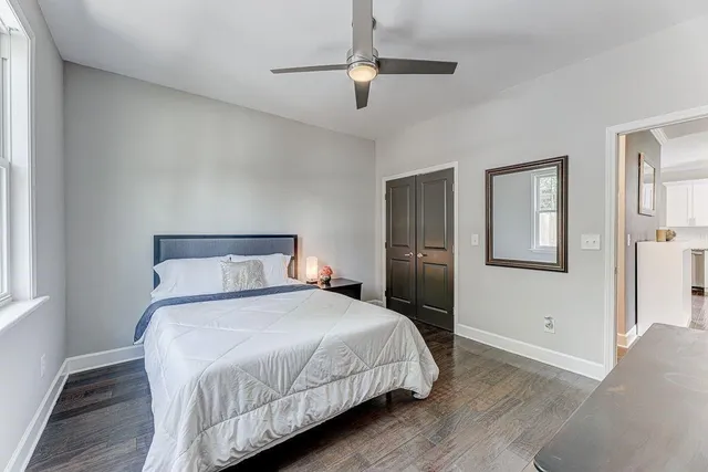 a bedroom with a large bed and a chandelier