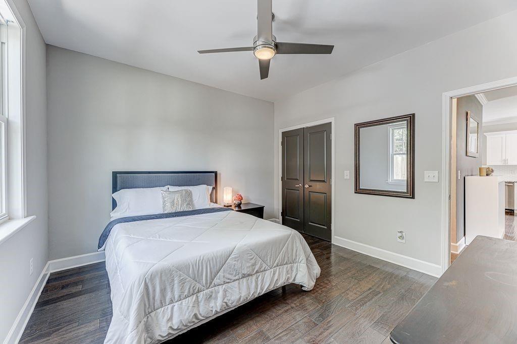 1922 Brannen Road Southeast Atlanta, GA 30316 - Photo 16 of 21 a bedroom with a large bed and a chandelier