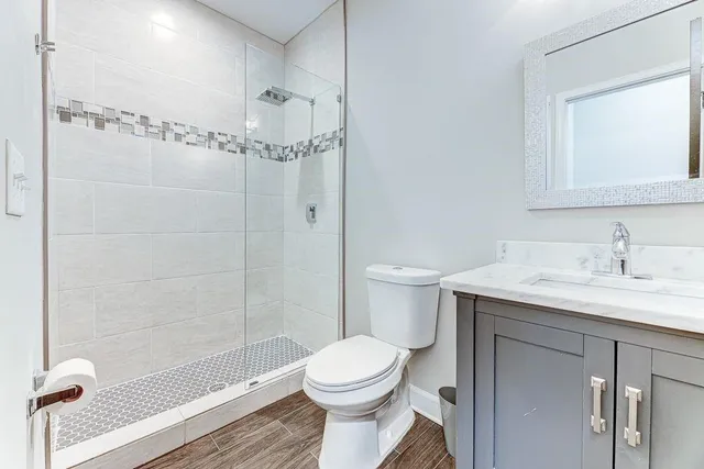 a bathroom with a sink toilet and shower