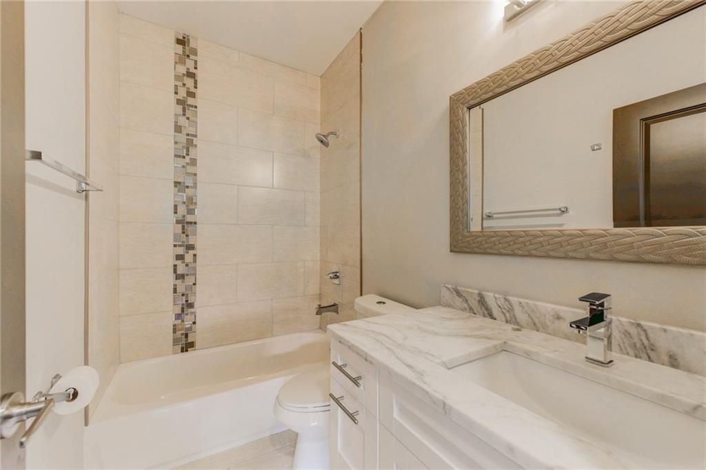 1922 Brannen Road Southeast Atlanta, GA 30316 - Photo 19 of 21 a bathroom with a granite countertop sink and a mirror