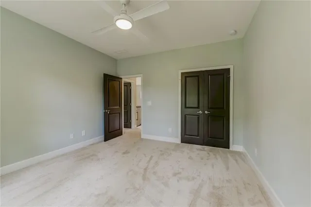 an empty room with closet and entryway