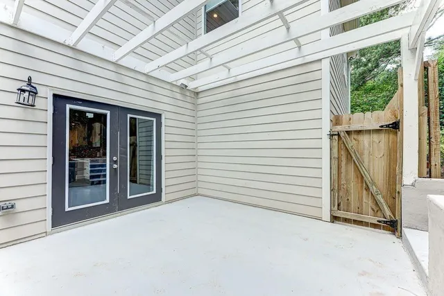 a view of a patio with table and chairs