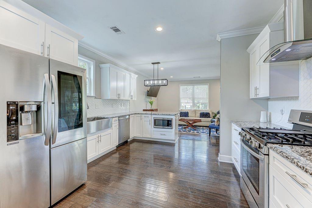 1922 Brannen Road Southeast Atlanta, GA 30316 - Photo 7 of 21 a kitchen with white cabinets and stainless steel appliances