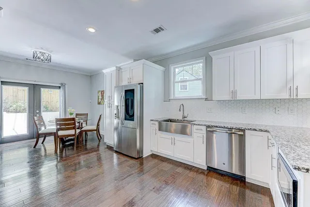 a kitchen with white cabinets and stainless steel appliances