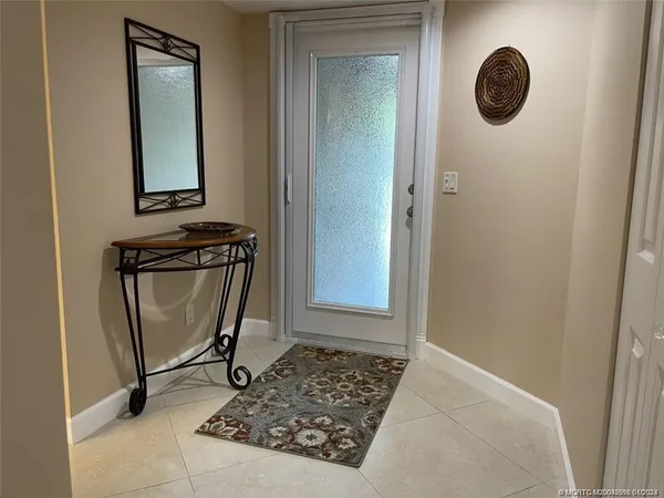 a view of a door and a mirror in a bathroom
