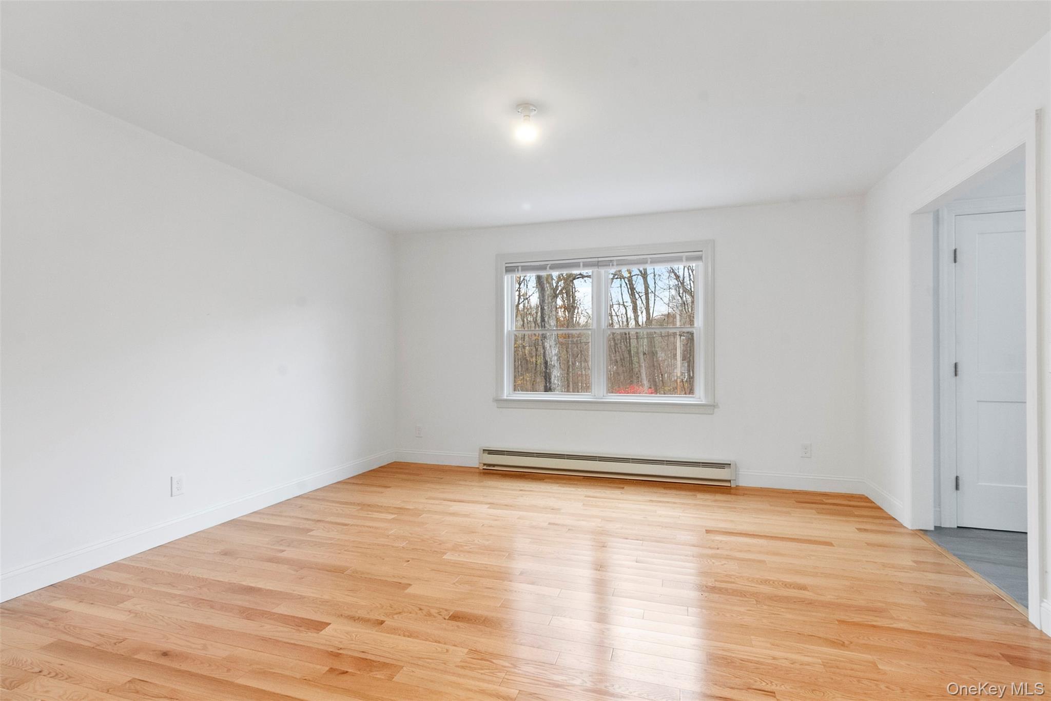 7 Tulip Road Lincolndale, NY 10541 - Photo 9 of 24 a view of an empty room with wooden floor and a window