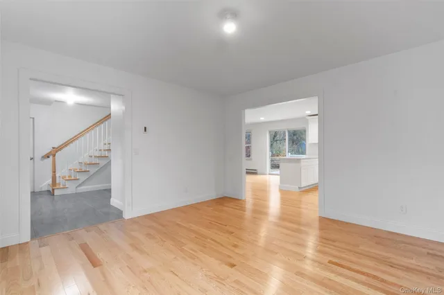 a view of empty room with wooden floor and fireplace
