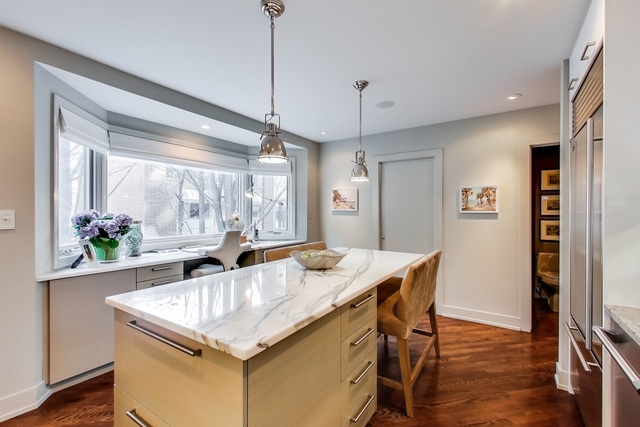 55 West Goethe Street, Unit 1233 Chicago, IL 60610 - Photo 12 of 31 a kitchen with granite countertop a table chairs stove and refrigerator