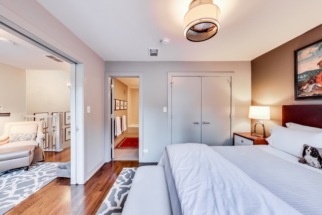 55 West Goethe Street, Unit 1233 Chicago, IL 60610 - Photo 20 of 31 a bedroom with bed and wooden floor