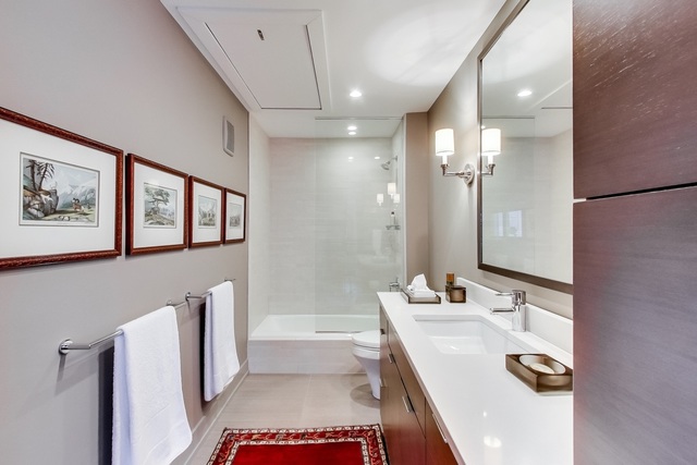 55 West Goethe Street, Unit 1233 Chicago, IL 60610 - Photo 21 of 31 a bathroom with a sink tub and a mirror