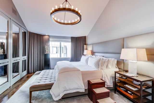 55 West Goethe Street, Unit 1233 Chicago, IL 60610 - Photo 23 of 31 a bedroom with a bed window and a chandelier