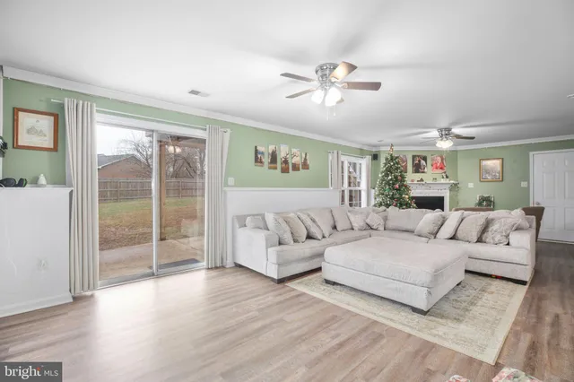 a living room with furniture and flowers