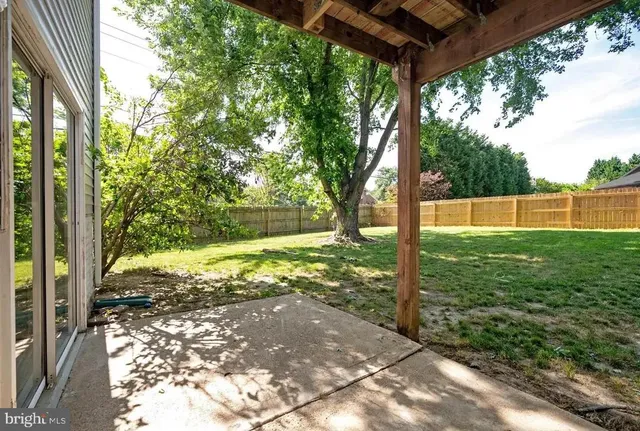 an aerial view of house with yard and outdoor seating