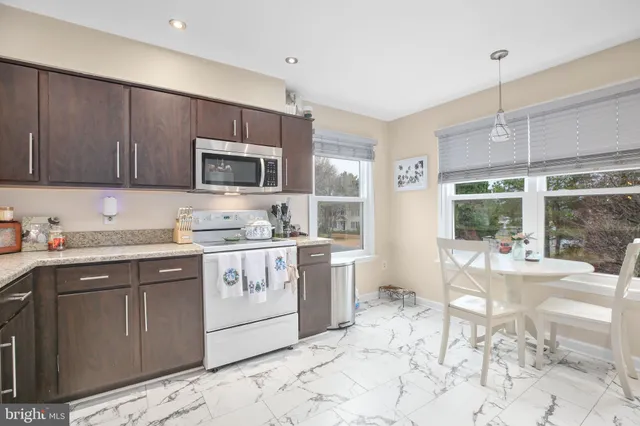 a kitchen with a stove a sink and a refrigerator