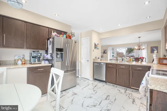 a kitchen with a sink cabinets and stainless steel appliances